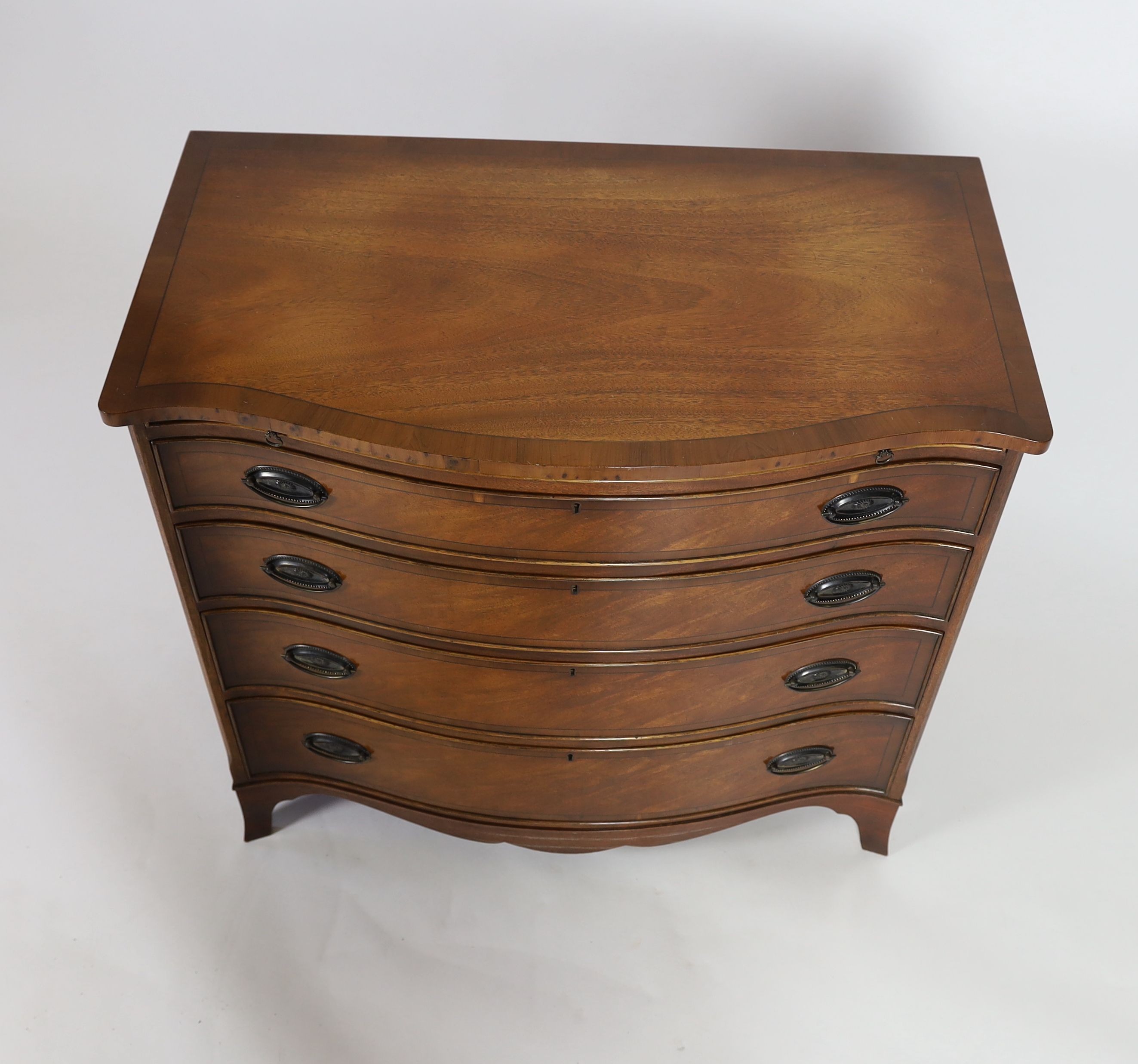 A reproduction George III design mahogany serpentine chest, with brushing slide, width 92cm depth 51cm height 85cm